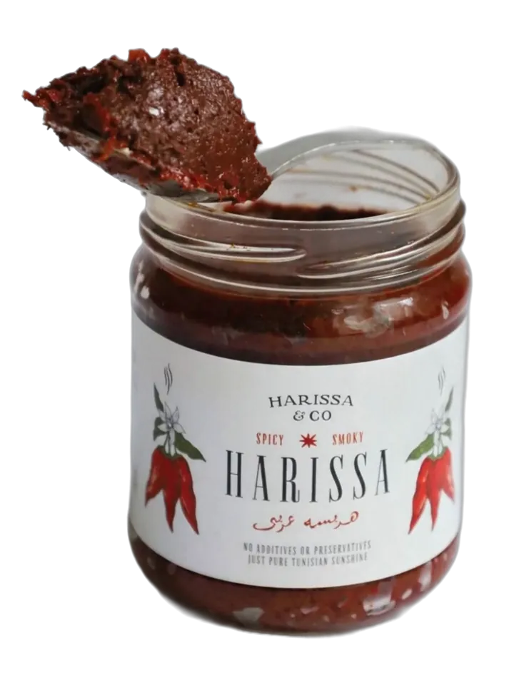 An open jar of Harissa & Co smoked harissa with a spoonful lifted out